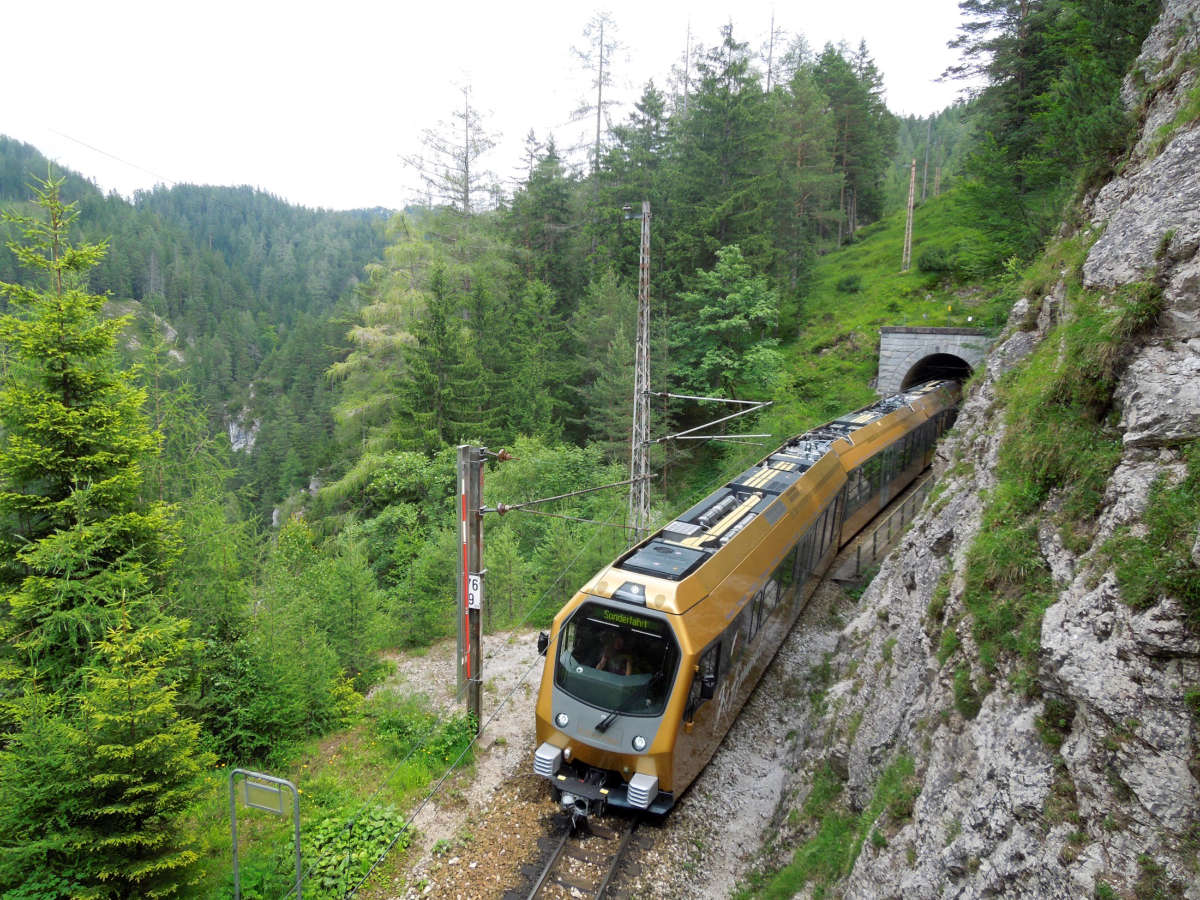 Mariazellerbahn Garnitur bei Ausfahrt aus Tunnel von schräg oben